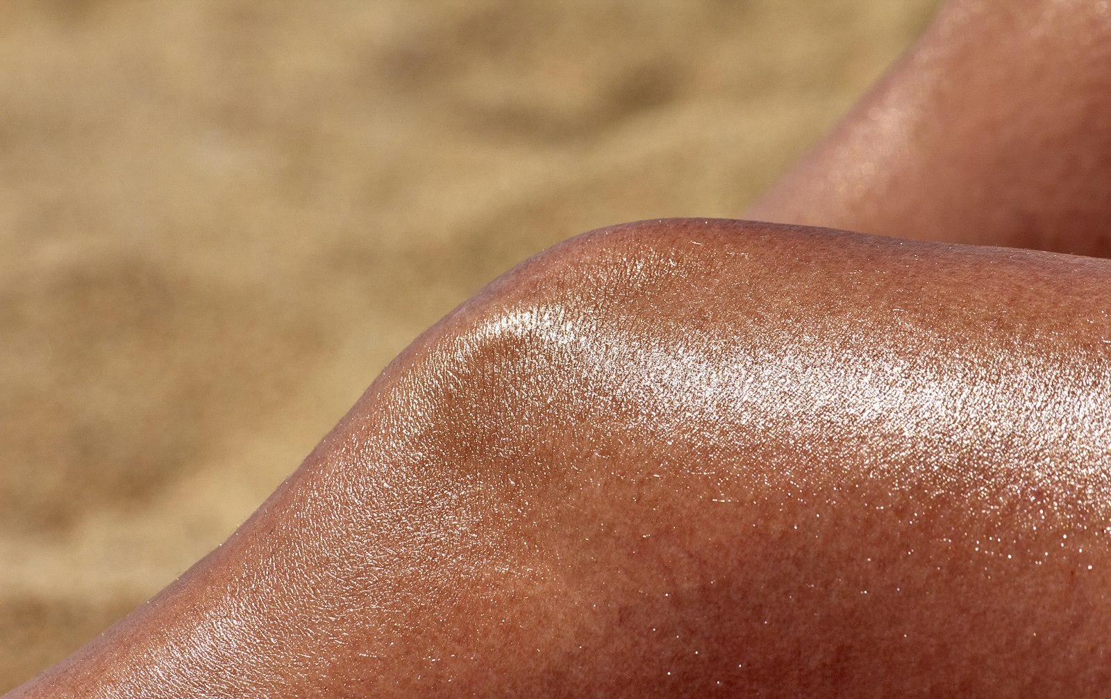 Close view of sun-kissed, glowing tanned skin on a leg
